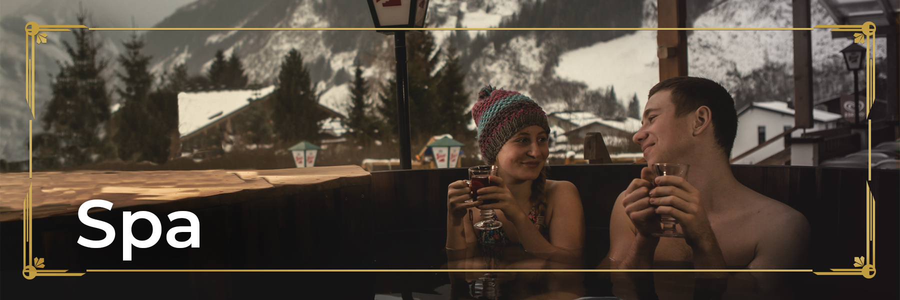 Girl and a boy sitting inside the wooden hot tub drinking tea